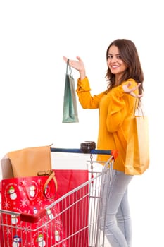 Woman carrying a shopping cart full of gifts