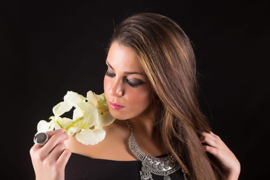 Young beautiful woman standing against black background