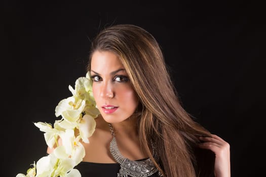 Young beautiful woman standing against black background