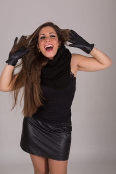 Young beautiful woman standing against gray