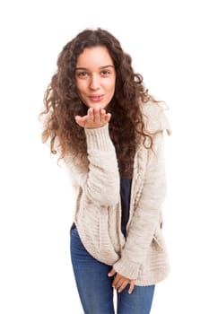 Beautiful young woman blowing you a kiss, isolated over white