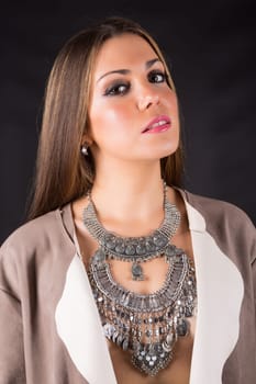 Young beautiful woman standing against black background