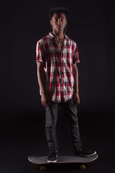 A young black skater posing in studio