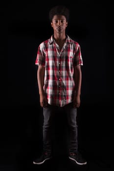 A casual young black boy posing isolated