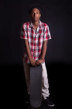 A young black skater posing in studio