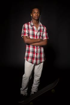 A young black skater posing in studio