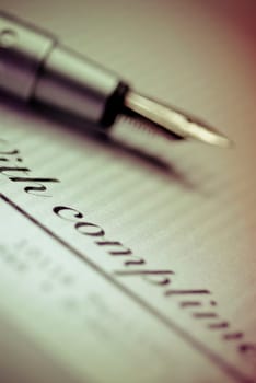 Close_up of a fountain pen on a paper
