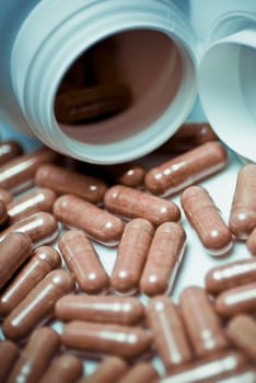 Close_up of capsules spilling out from a pill bottle