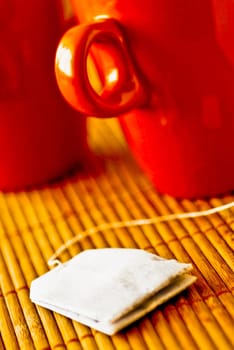 Close_up of tea cups and a teabag