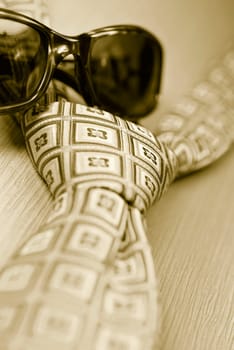 Close_up of sunglasses with a tie