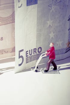 Figurine of a manual worker with European union banknotes