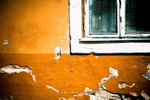 Close_up of a window on a weathered wall