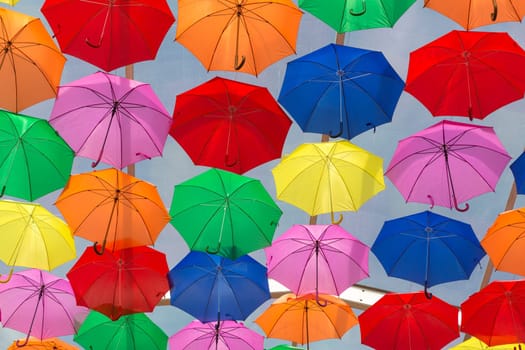 Lots of umbrellas coloring the sky in the city of Agueda, Portugal