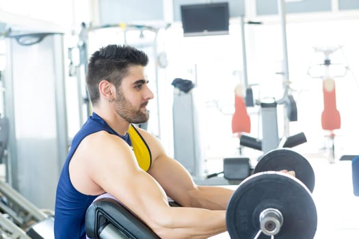 Handsome young man working out at the gym
