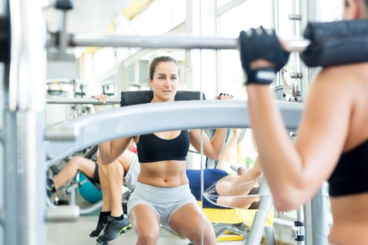 A young and beautiful woman working out at the gym