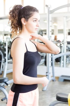 A young and beautiful woman working out at the gym