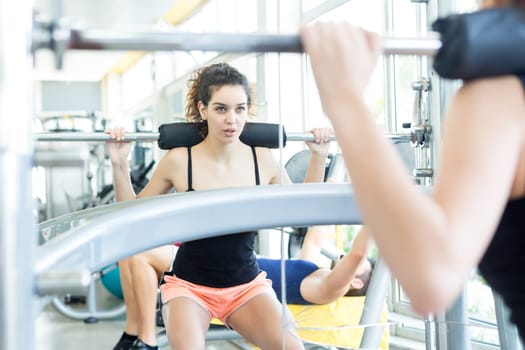 A young and beautiful woman working out at the gym