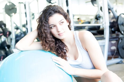 A young and beautiful woman working out at the gym