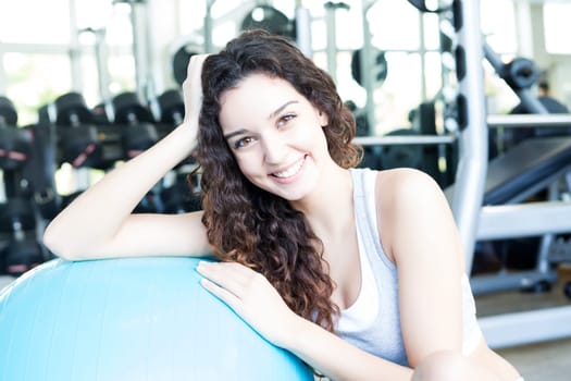A young and beautiful woman working out at the gym