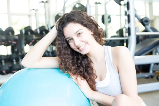 A young and beautiful woman working out at the gym