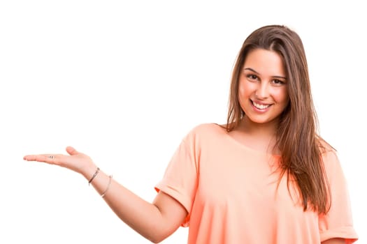 Young beautiful woman presenting your product, isolated over white background