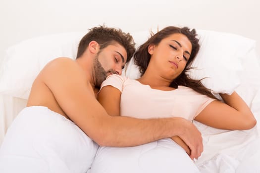 A beautiful young passionate couple in bed