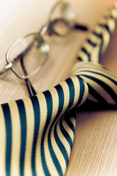Close_up of eyeglasses with a tie