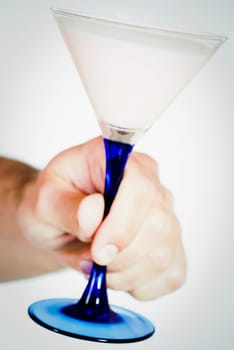 Close_up of a personŽs hand holding a martini glass