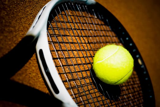 Close_up of a tennis ball on a tennis racket