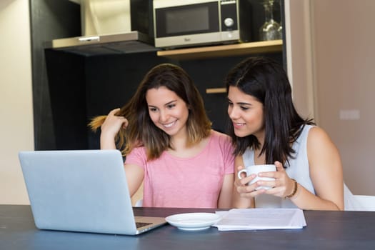 Beautiful young women at home studying for the final exams