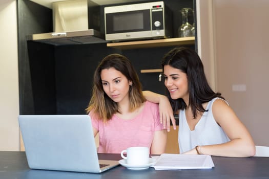 Beautiful young women at home studying for the final exams