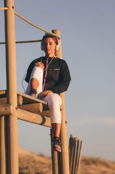 Young beautiful chinese woman exercising at the beach at sunrise/sunset
