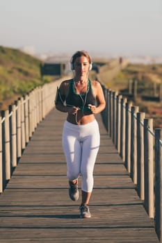 Young beautiful chinese woman exercising at the beach at sunrise/sunset