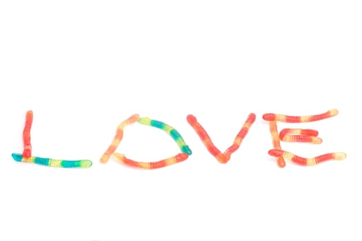 LOVE, written with gummy snakes, isolated on white