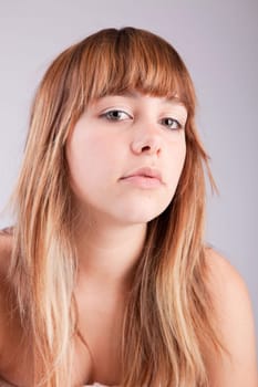 Beautiful woman posing, isolated over grey background