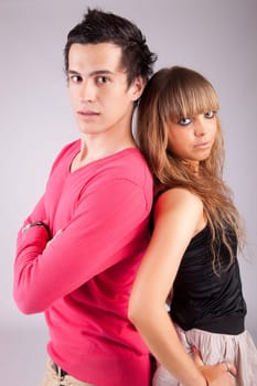 Young casual couple posing isolated