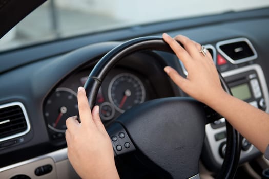 Young woman in luxury sports car