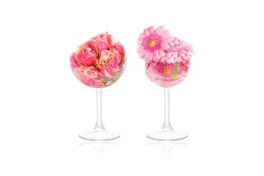 Marguerite and rose flowers in tall glasses