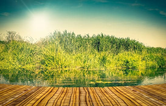 Colourful lake landscape with a bamboo pier