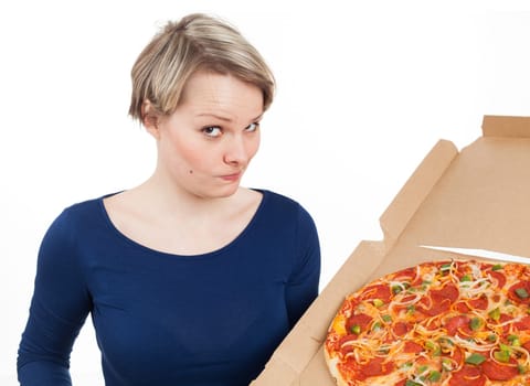 Young woman holding a pizza from fast-food with the desire of eating it, isolated on white