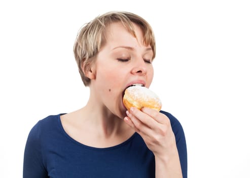 Young woman eating a donut, isolated on white