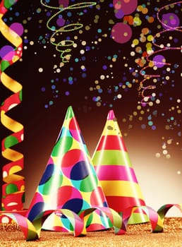 Festive Decoration Concept - Close up Colorful Party Hats and Streamers on Abstract Background