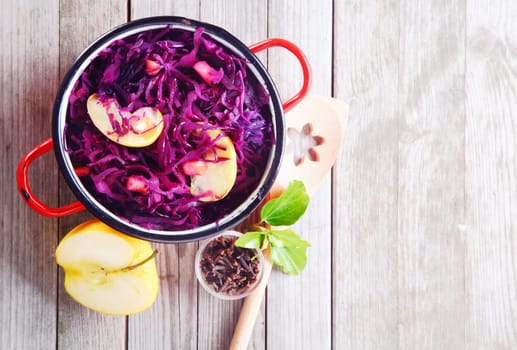 Aerial Shot of Gourmet Fresh Purple Cabbage and Apple Salad on Top of Wooden Table. Emphasizing Copy Space.