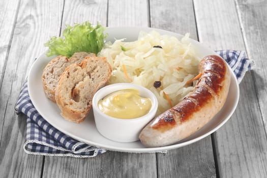 Close up Fresh Vegetable Salad and Sausage on White Plate with Bread and Mustard Sauce, Placed on Wooden Table.