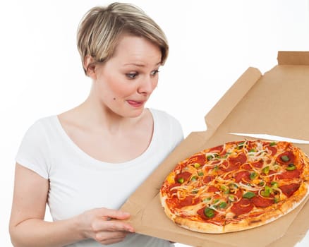 Young woman looking at a pizza and drooling over, isolated on white