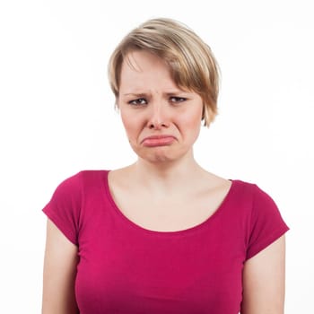 Young woman with an unhappy expression, isolated on white