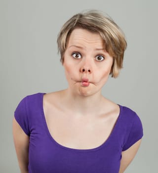 Portrait of a funny young woman grimacing