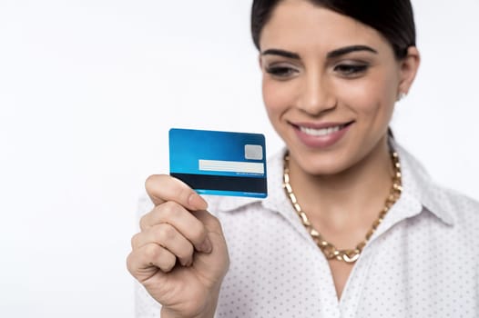 Smiling young woman checking her cash card