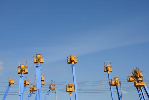 Cherry picker platform against a blue sky