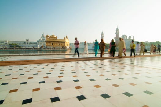 Group of Sikh pilgrims walking by the holy pool, Golden Temple, Amritsar, Pun jab state, India, Asia